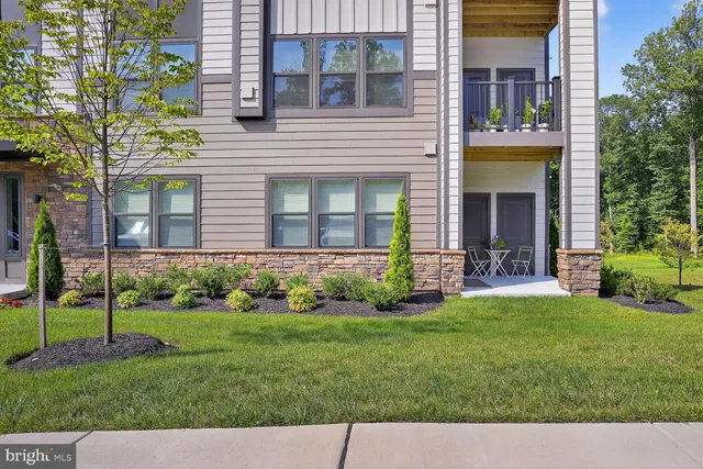 a view of a house with a yard and plants