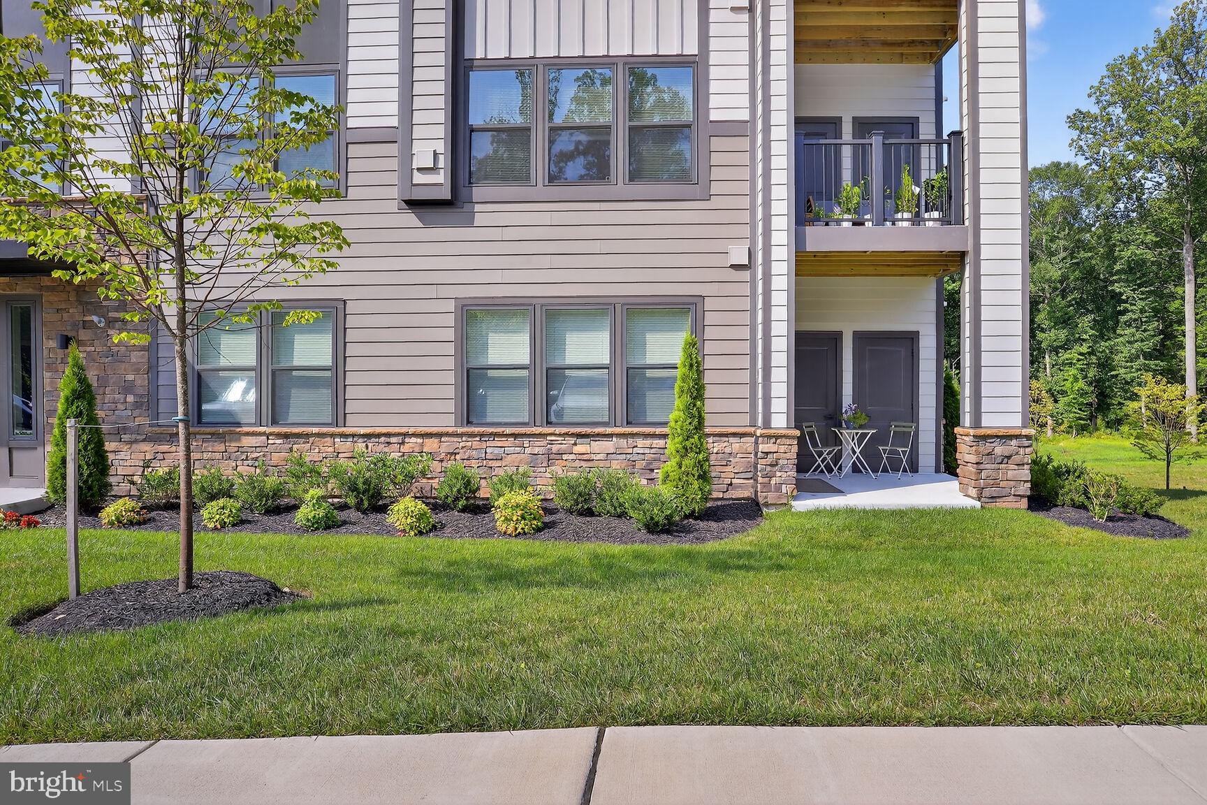 10401 Resort Road, Unit E Ellicott City, MD 21042 - Photo 42 of 44 a view of a house with a yard and plants