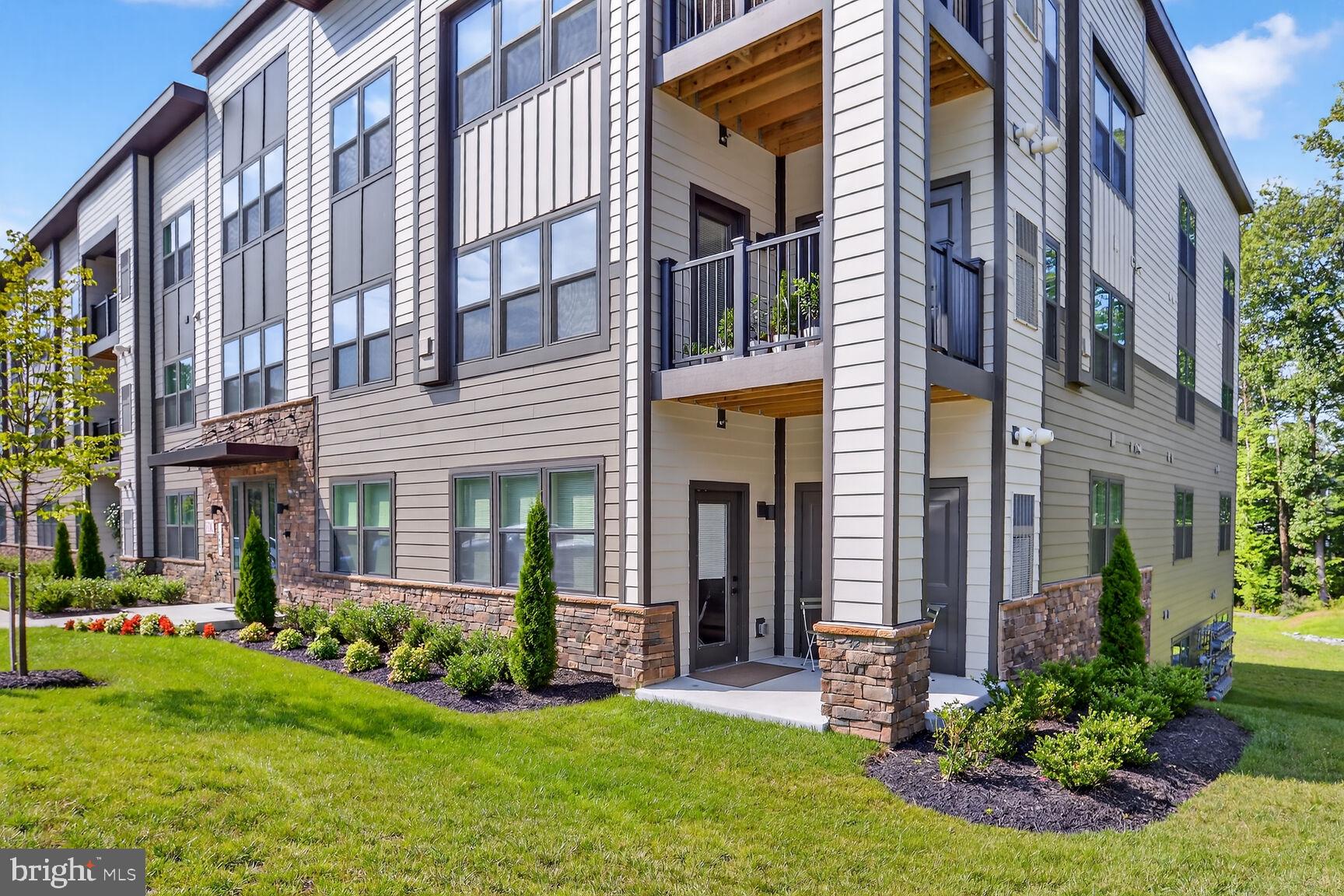 10401 Resort Road, Unit E Ellicott City, MD 21042 - Photo 44 of 44 a view of a brick building with a yard