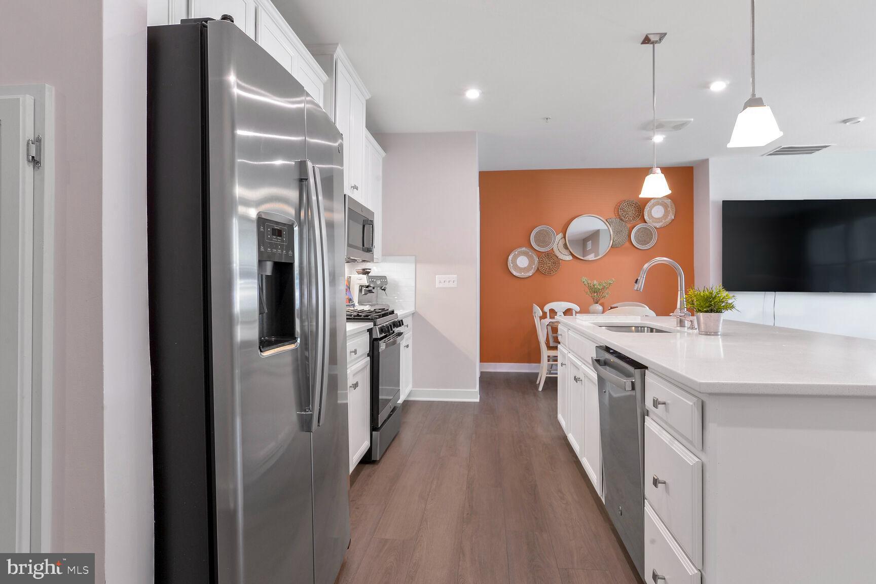 10401 Resort Road, Unit E Ellicott City, MD 21042 - Photo 5 of 44 a large kitchen with stainless steel appliances granite countertop a sink a refrigerator and a stove