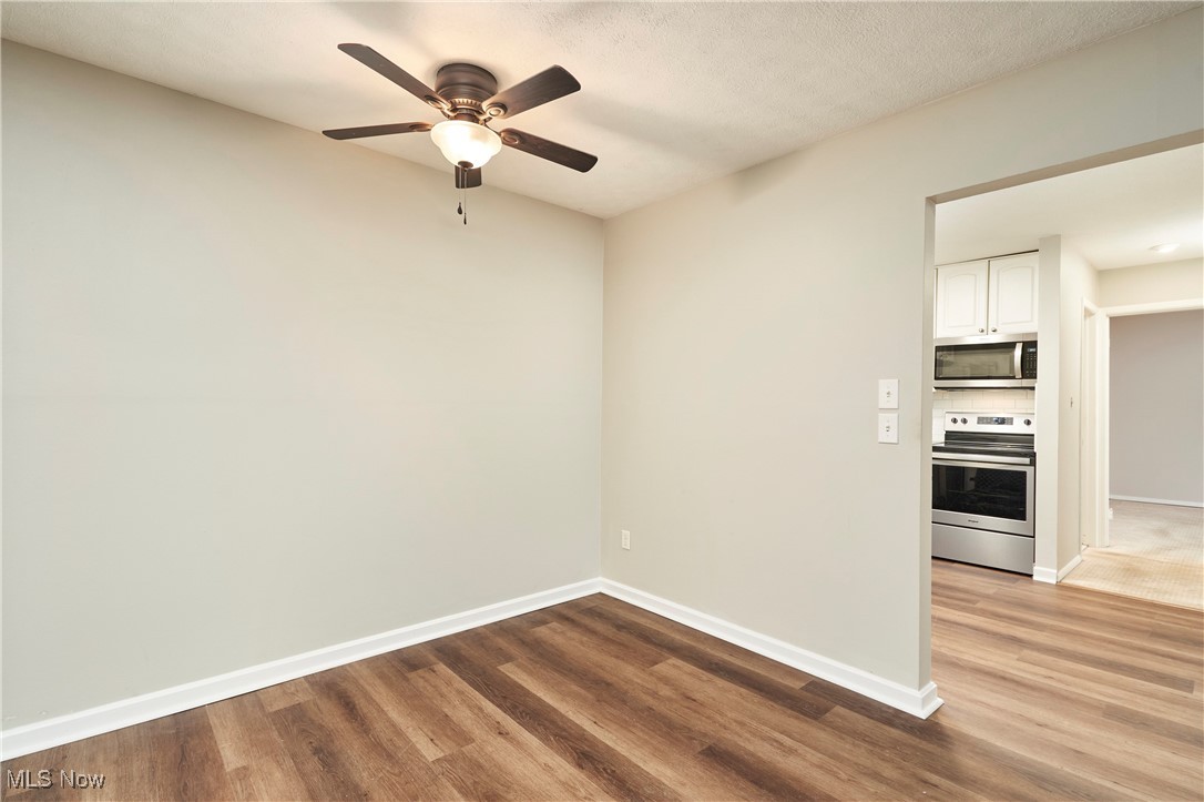 10744 Valley View Road, Unit B13 Northfield, OH 44067 - Photo 3 of 14 Unfurnished room with light wood-style flooring and ceiling fan