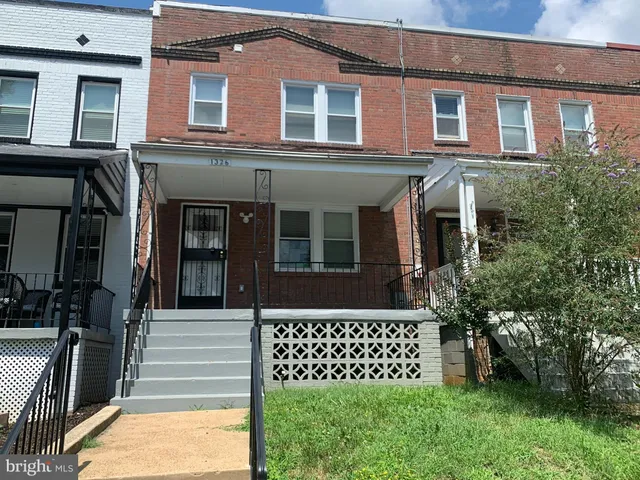 a view of a brick house with a large windows