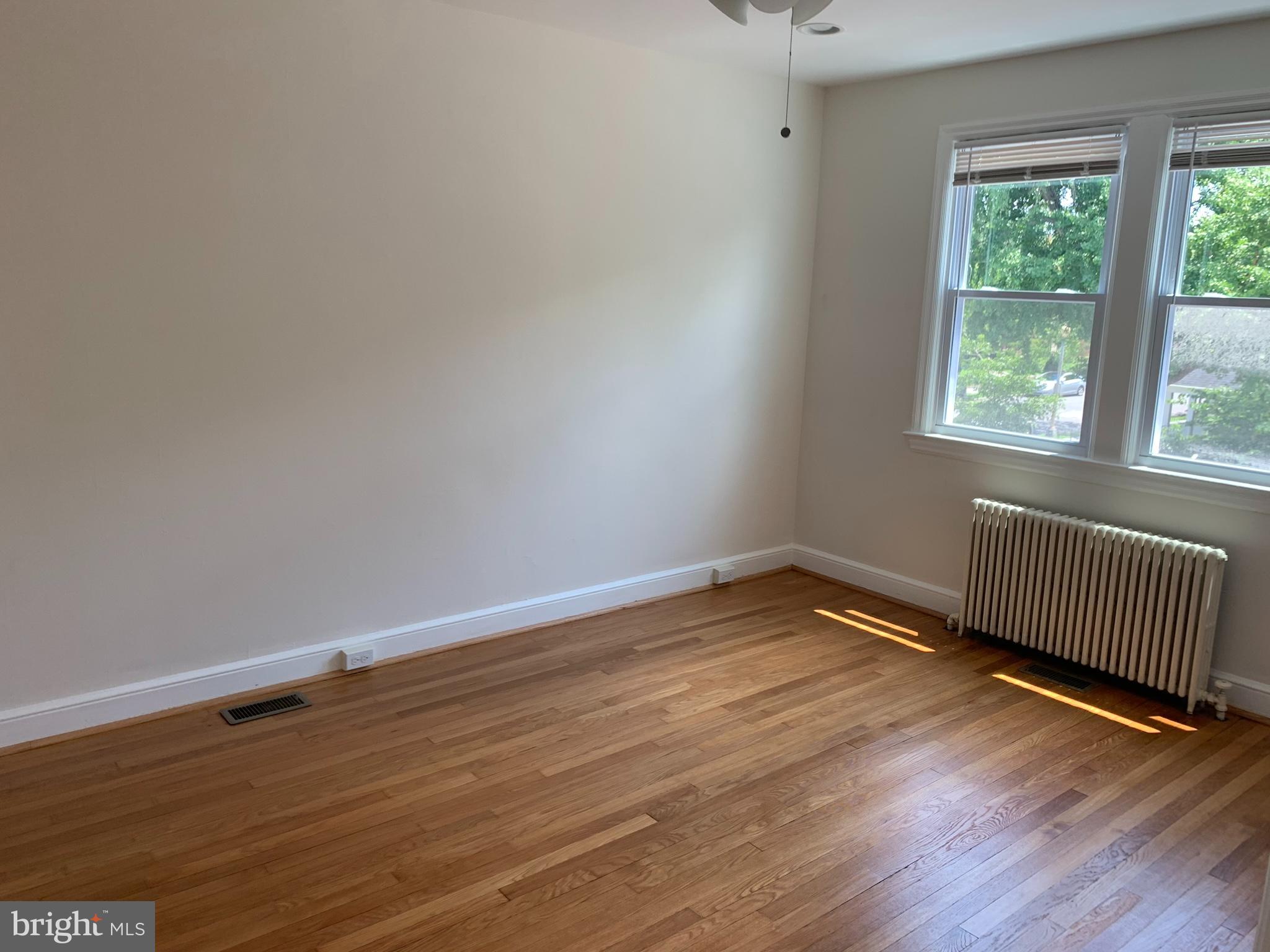 1326 Holbrook Street Northeast Washington, DC 20002 - Photo 17 of 21 a view of an empty room with wooden floor and a window