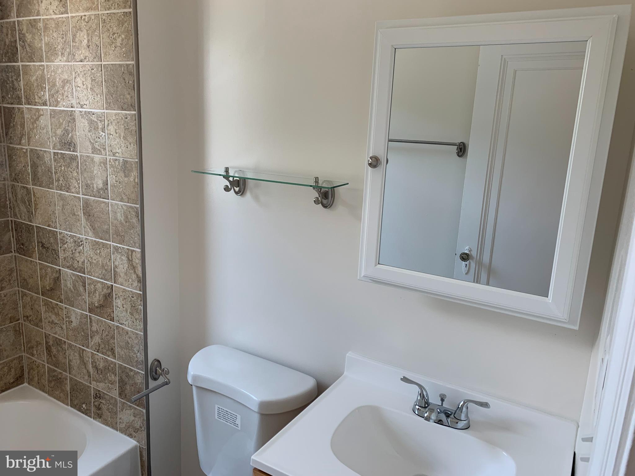 1326 Holbrook Street Northeast Washington, DC 20002 - Photo 20 of 21 a bathroom with a sink toilet and a mirror