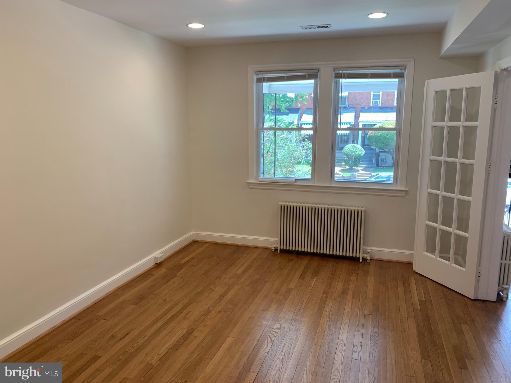 1326 Holbrook Street Northeast Washington, DC 20002 - Photo 5 of 21 an empty room with wooden floor and windows
