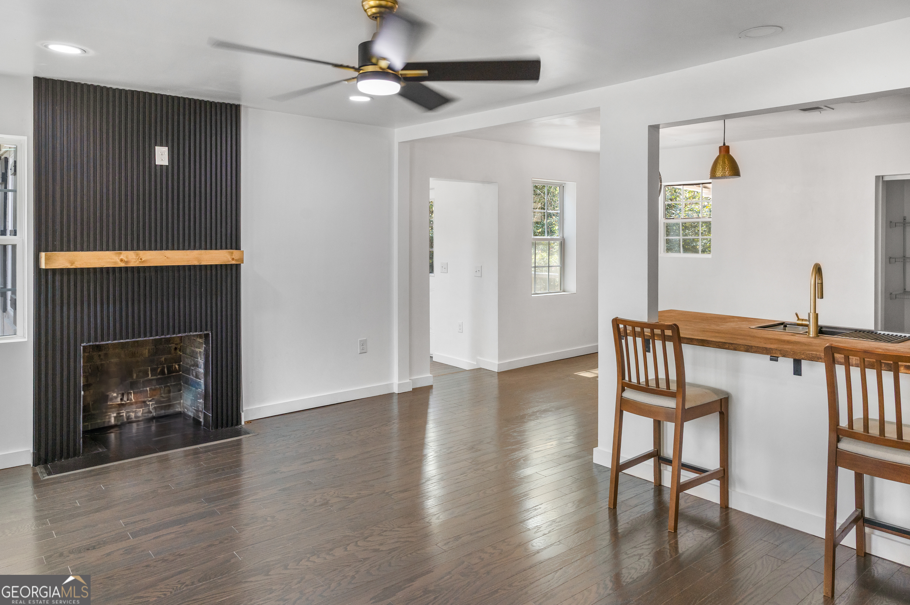 104 Halcyondale Road Sylvania, GA 30467 - Photo 6 of 33 a living room with wooden floor and a fireplace