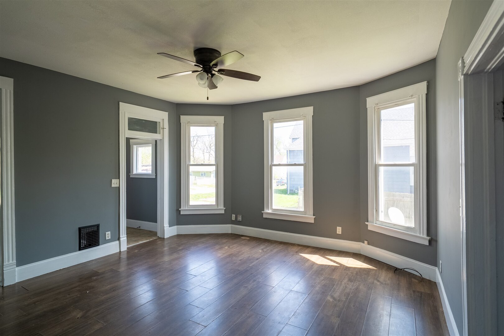 902 West Grove Street Bloomington, IL 61701 - Photo 11 of 17 a view of an empty room with wooden floor and a window
