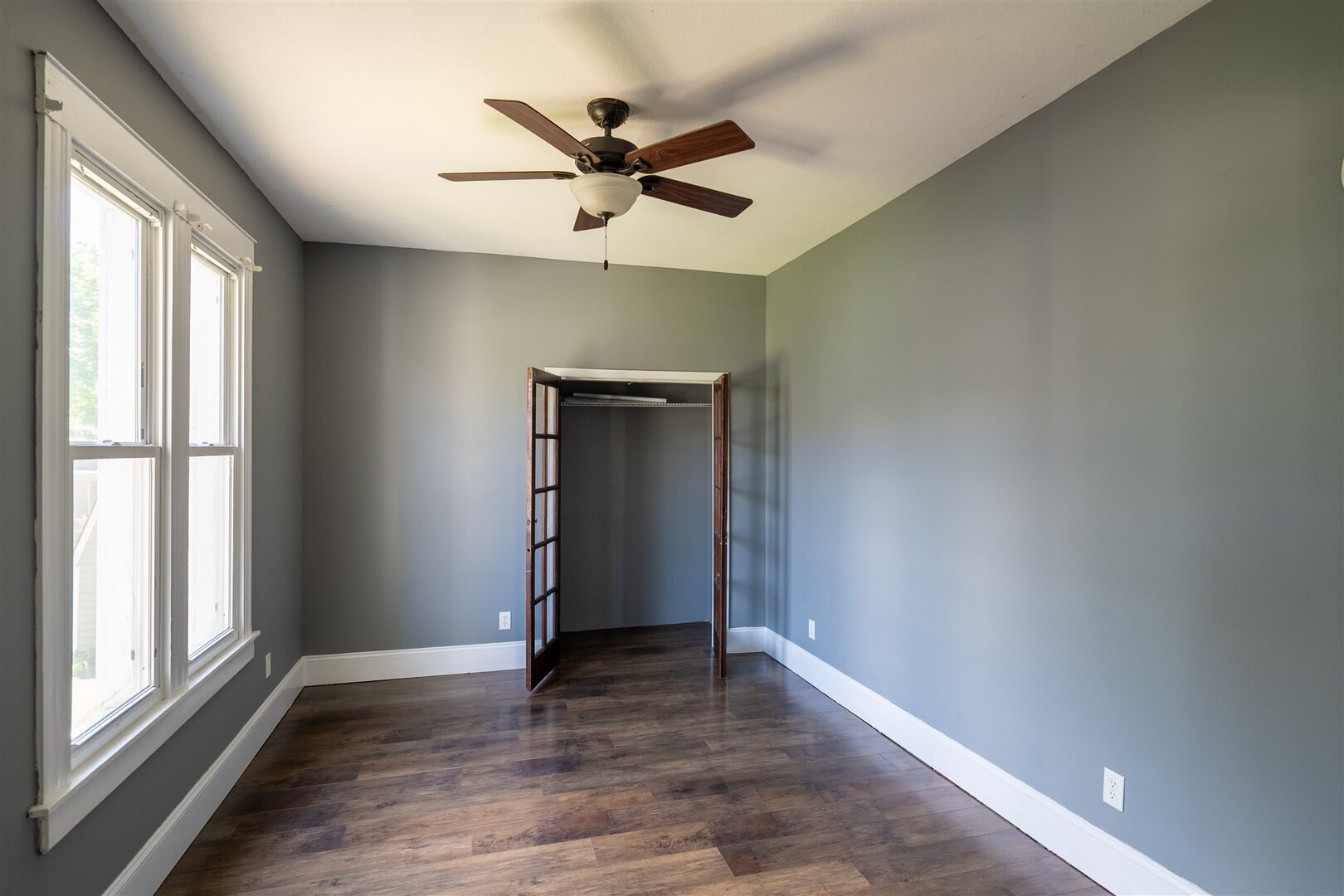 902 West Grove Street Bloomington, IL 61701 - Photo 12 of 17 wooden floor in an empty room with a window