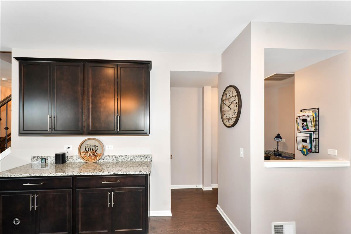 1500 Pine Drive Woodridge, IL 60517 - Photo 13 of 30 a bathroom with a granite countertop sink and a refrigerator