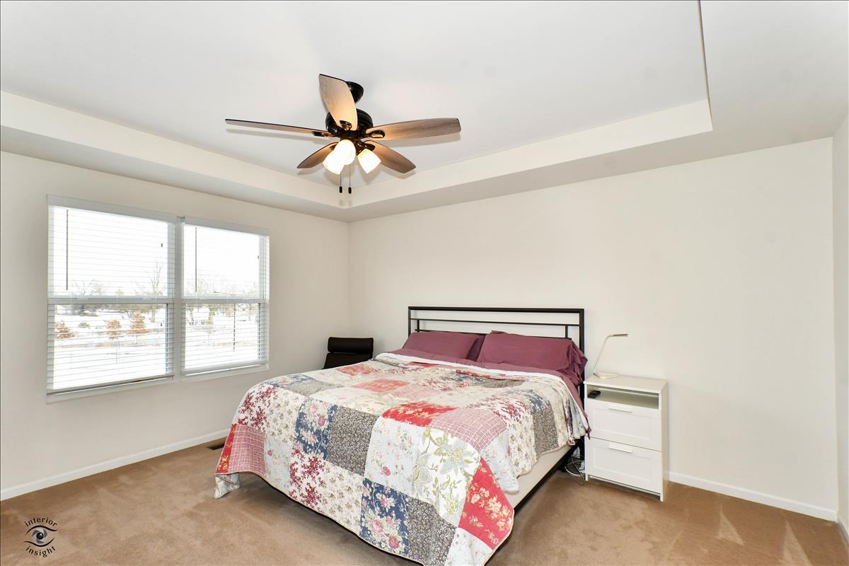 1500 Pine Drive Woodridge, IL 60517 - Photo 16 of 30 a bedroom with a large bed and a window