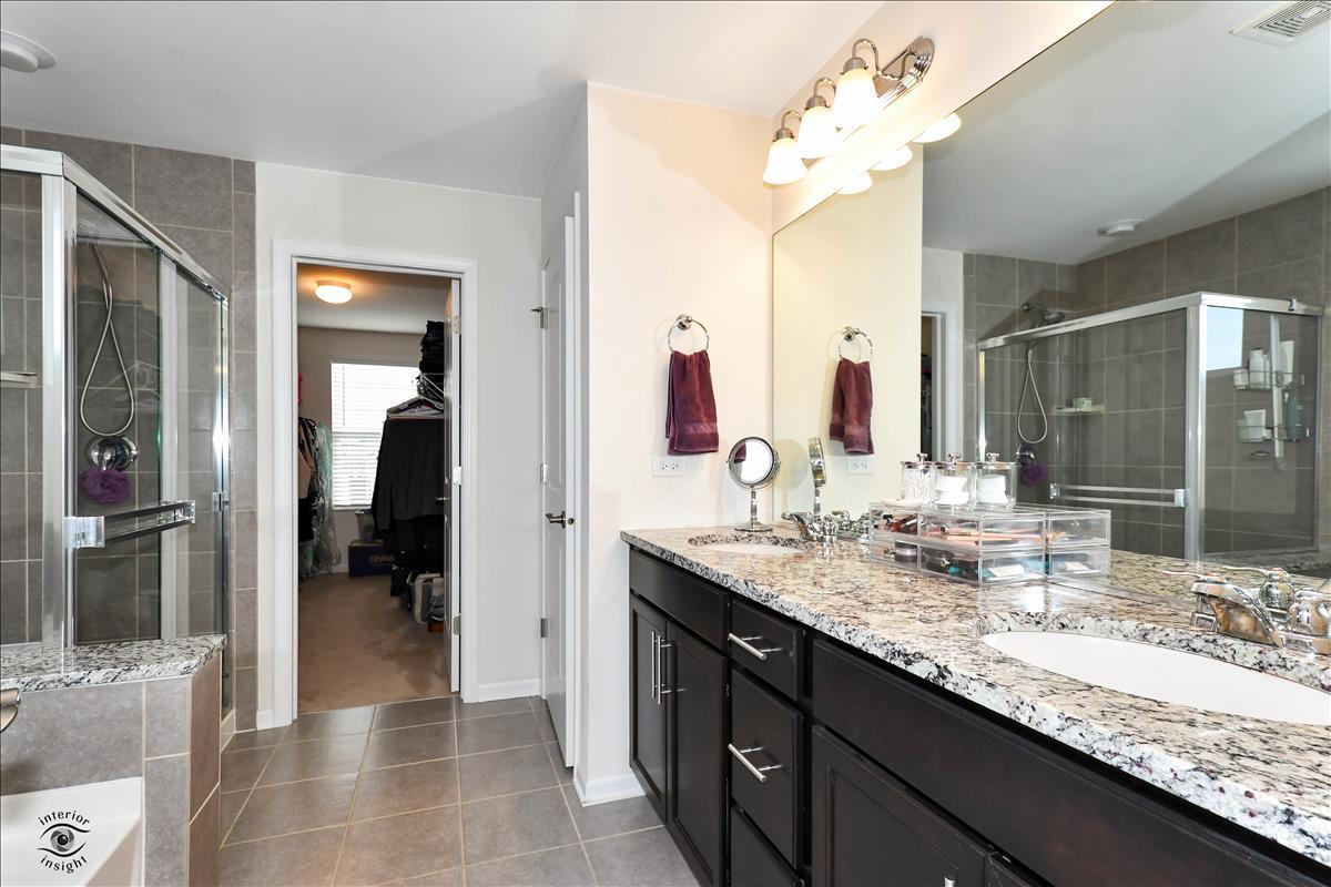 1500 Pine Drive Woodridge, IL 60517 - Photo 17 of 30 a bathroom with a granite countertop sink and a mirror