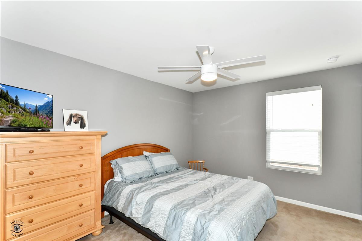 1500 Pine Drive Woodridge, IL 60517 - Photo 19 of 30 a bedroom with a bed a window and a dresser