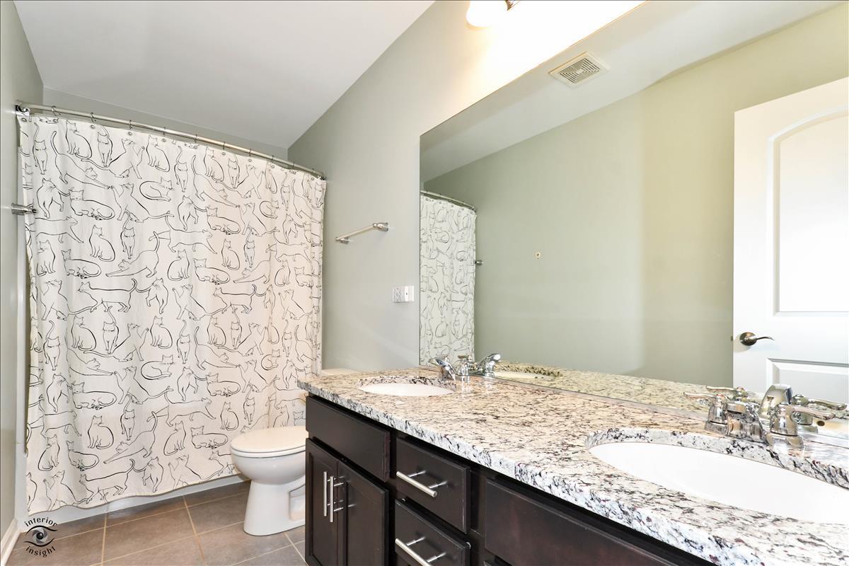 1500 Pine Drive Woodridge, IL 60517 - Photo 22 of 30 a bathroom with a granite countertop sink toilet and shower