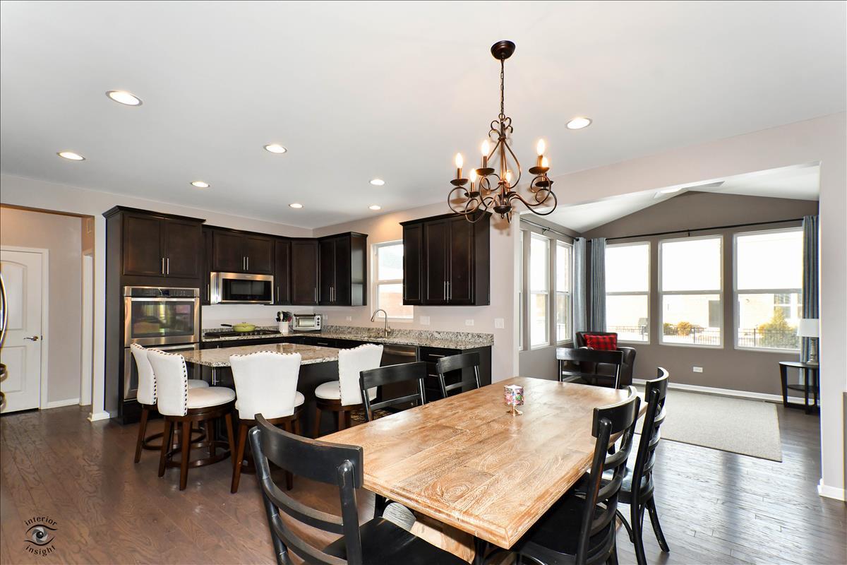 1500 Pine Drive Woodridge, IL 60517 - Photo 9 of 30 a large kitchen with a table and chairs
