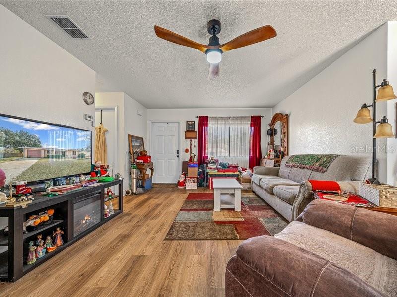 543 Silver Course Court Ocala, FL 34472 - Photo 6 of 21 a living room with furniture and a flat screen tv
