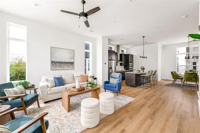 a living room with furniture and a wooden floor