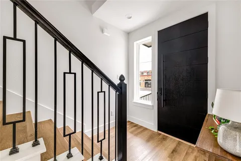 a view of an entryway with wooden floor and stairs
