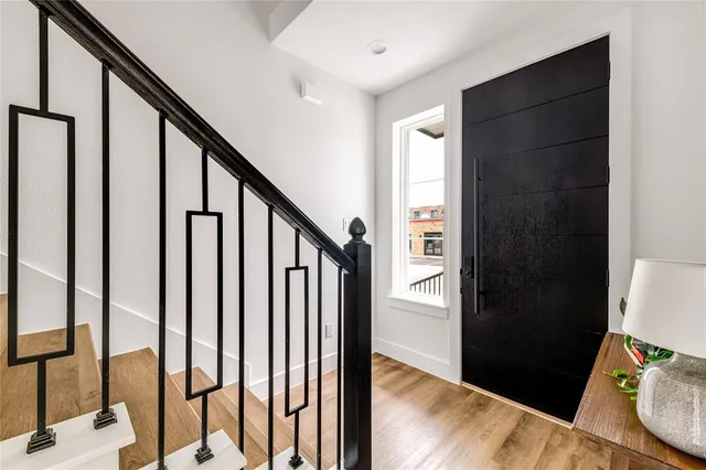 a view of an entryway with wooden floor and stairs