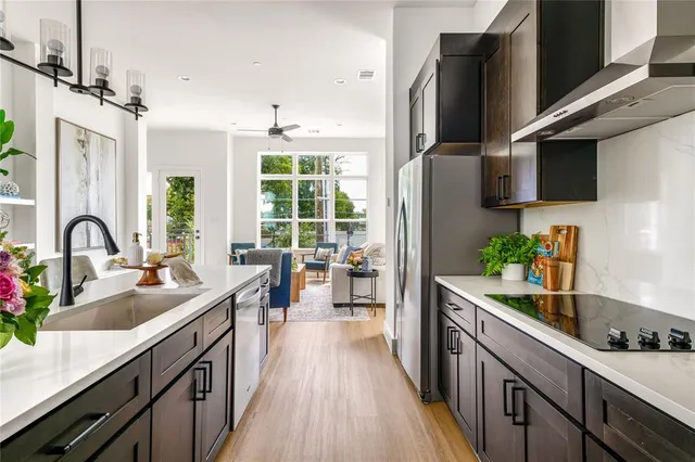 a kitchen with kitchen island granite countertop a sink appliances cabinets and a counter top space