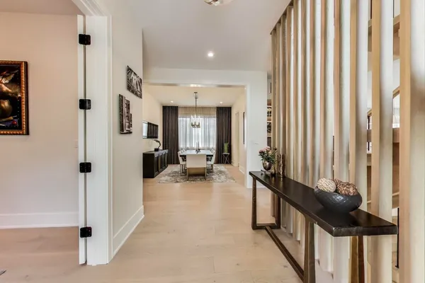 a view of a hallway with living room and dining room