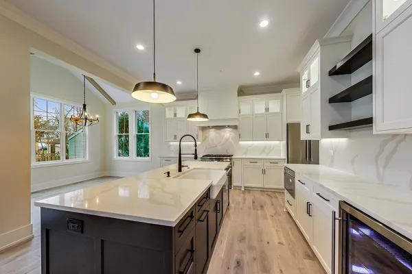 a kitchen with counter top space a sink and appliances