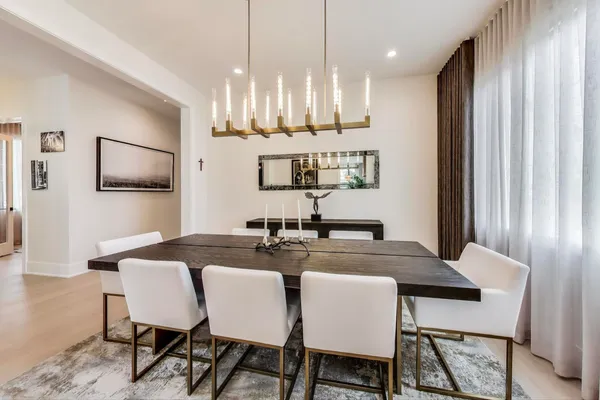 a view of a dining room and a kitchen with a table chairs