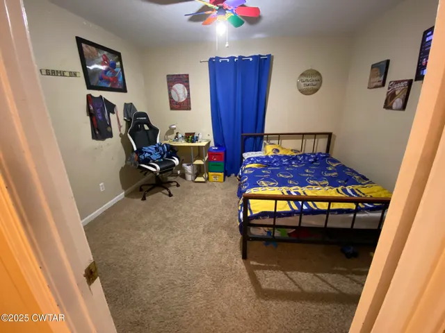 a bedroom with bed and window