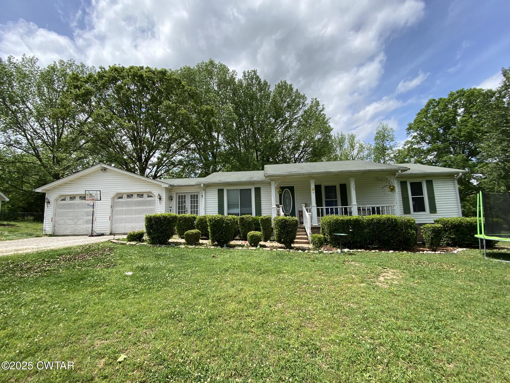 1100 Stewart Road Finger, TN 38334 - Photo 17 of 23 a front view of a house with a yard and trees