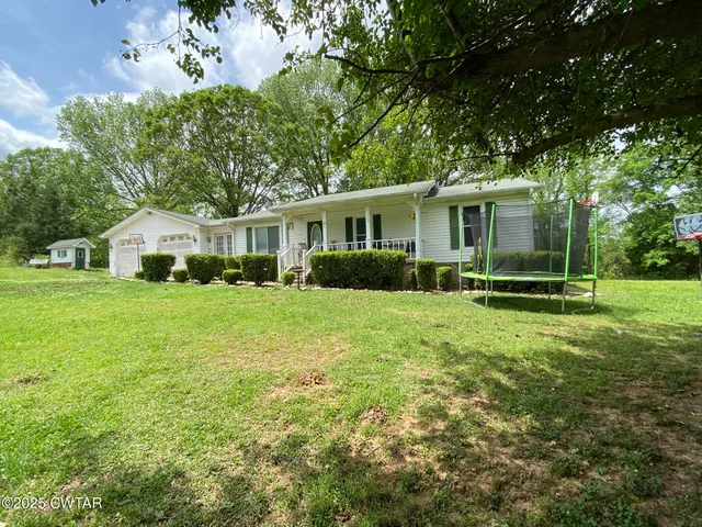 a front view of house with yard and green space