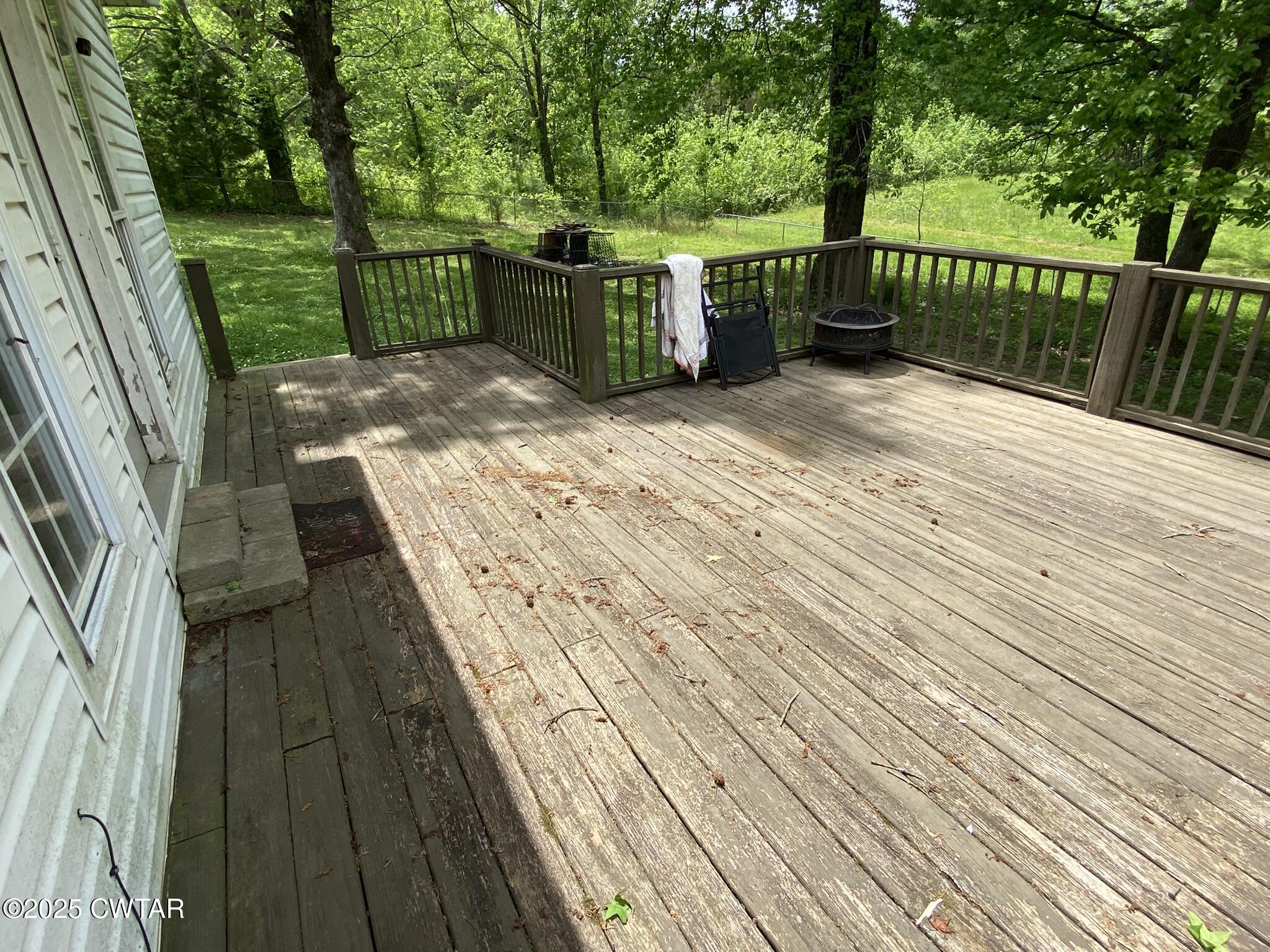 1100 Stewart Road Finger, TN 38334 - Photo 23 of 23 a view of a deck with wooden floor and fence with a large garden