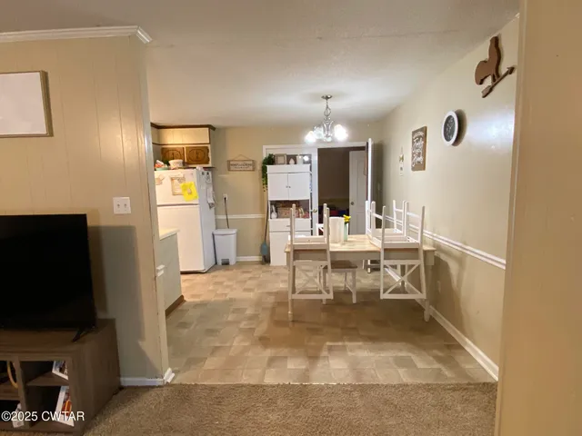 a view of a living room with furniture and a flat screen tv