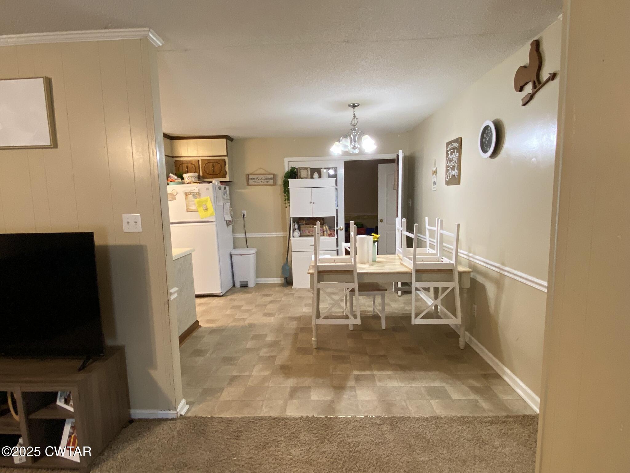 1100 Stewart Road Finger, TN 38334 - Photo 6 of 23 a view of a living room with furniture and a flat screen tv