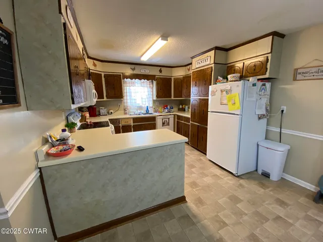 a living room with a couch and a refrigerator