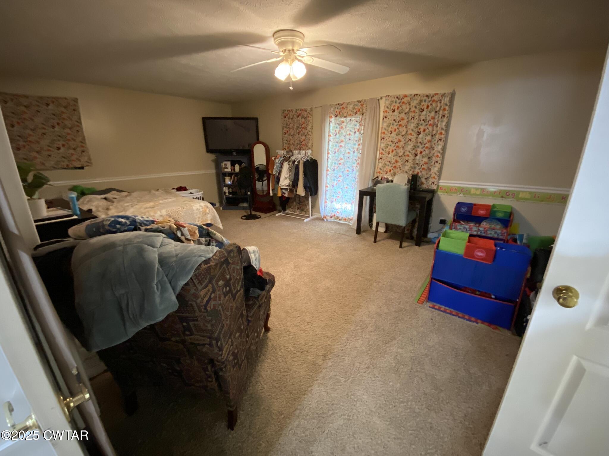 1100 Stewart Road Finger, TN 38334 - Photo 10 of 23 a bedroom with a bed and a chandelier