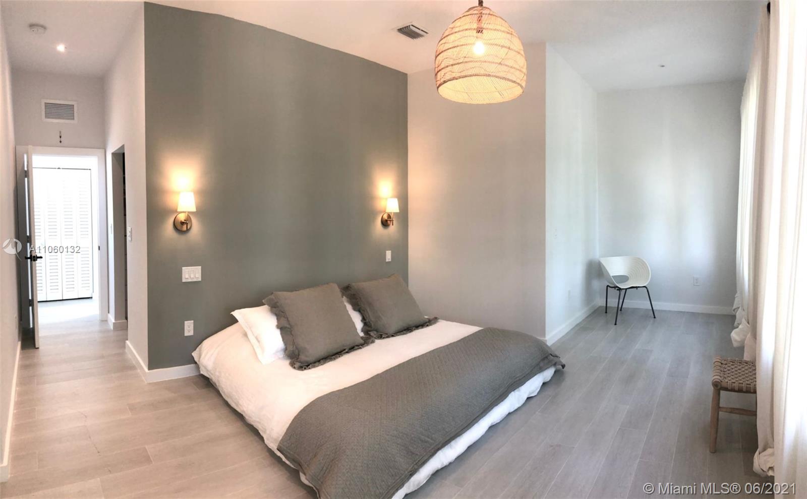 32 Southwest 23rd Road Miami, FL 33129 - Photo 15 of 27 a bedroom with a bed and a chandelier