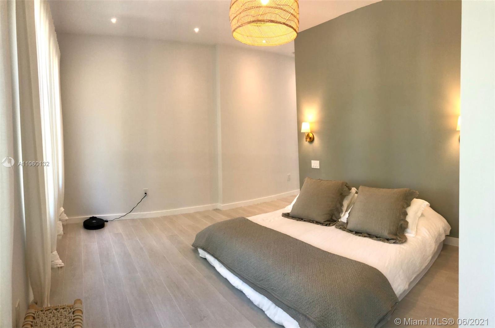 32 Southwest 23rd Road Miami, FL 33129 - Photo 16 of 27 a bedroom with a bed and a chandelier