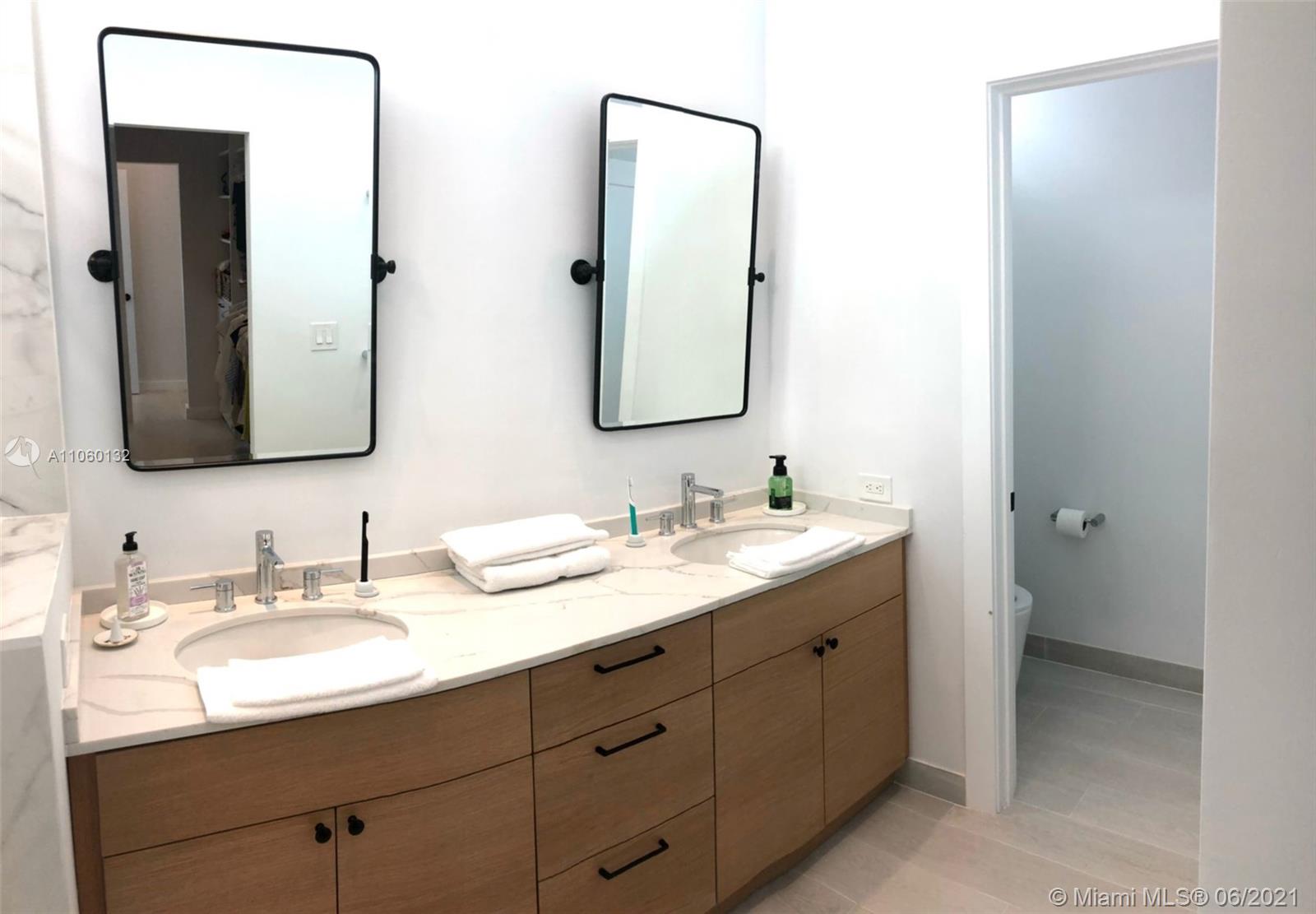 32 Southwest 23rd Road Miami, FL 33129 - Photo 24 of 27 a bathroom with a double vanity sink and mirror