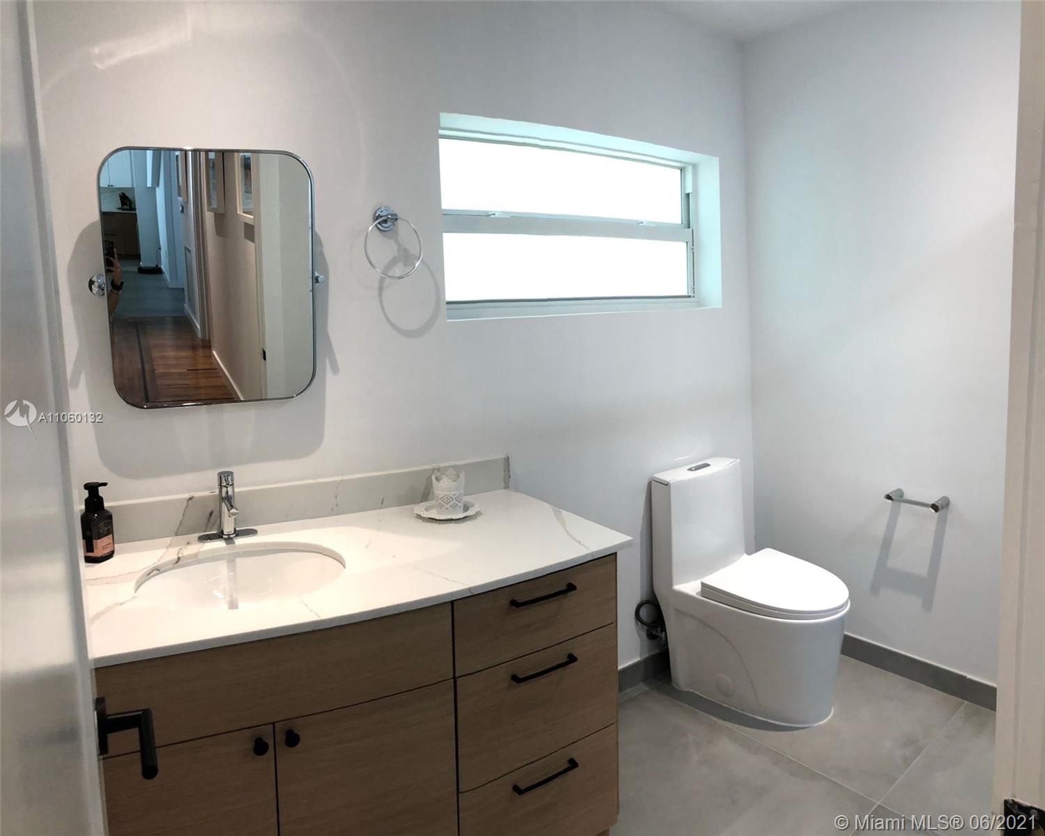 32 Southwest 23rd Road Miami, FL 33129 - Photo 25 of 27 a bathroom with a toilet sink and mirror
