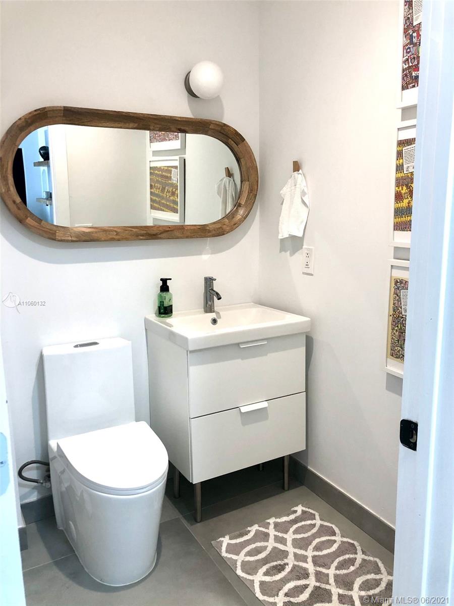 32 Southwest 23rd Road Miami, FL 33129 - Photo 27 of 27 a bathroom with a toilet sink and mirror