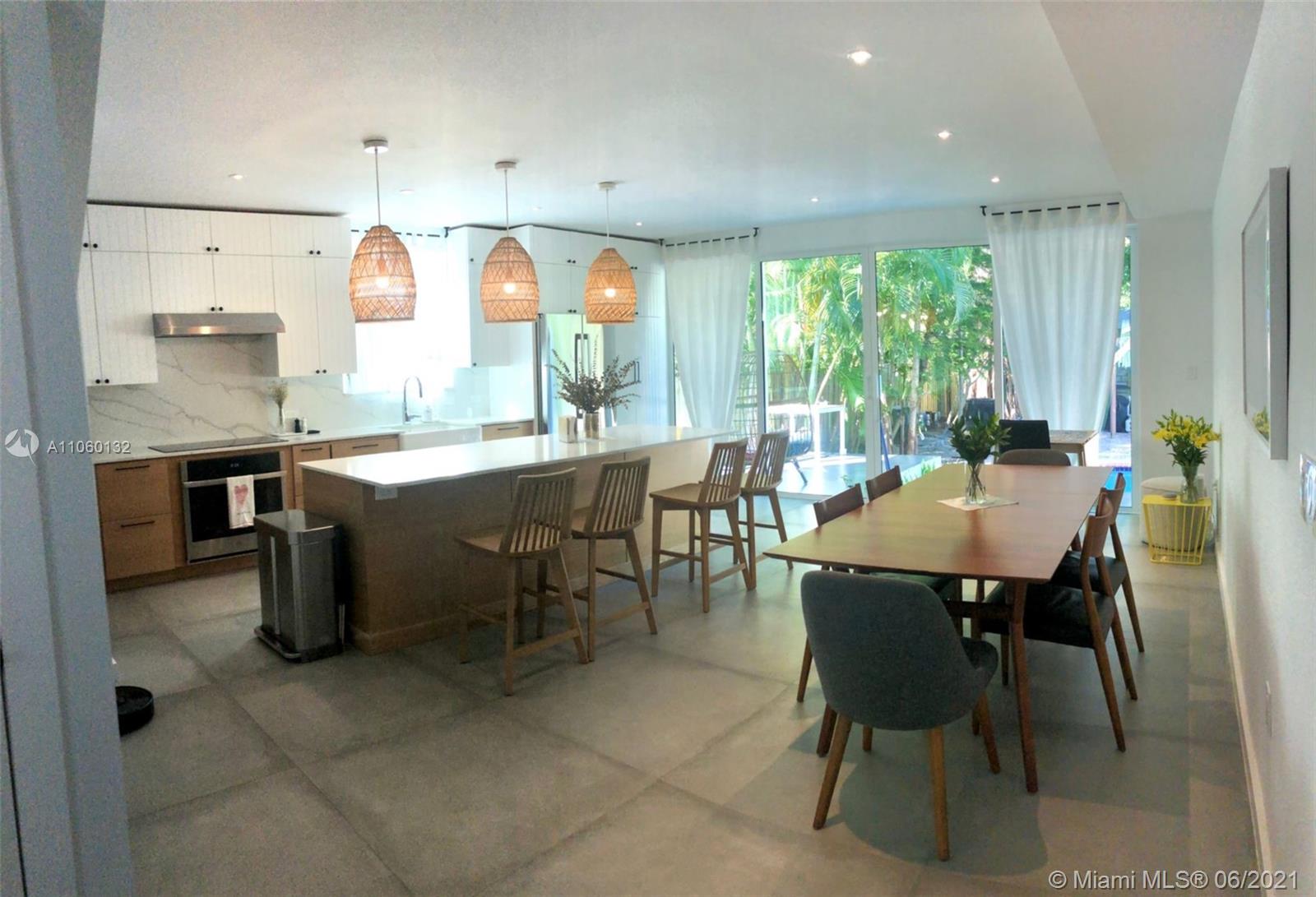 32 Southwest 23rd Road Miami, FL 33129 - Photo 10 of 27 a kitchen with a table and chairs in it