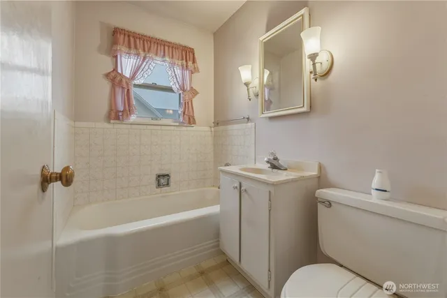 an empty room that has a window and kitchen view