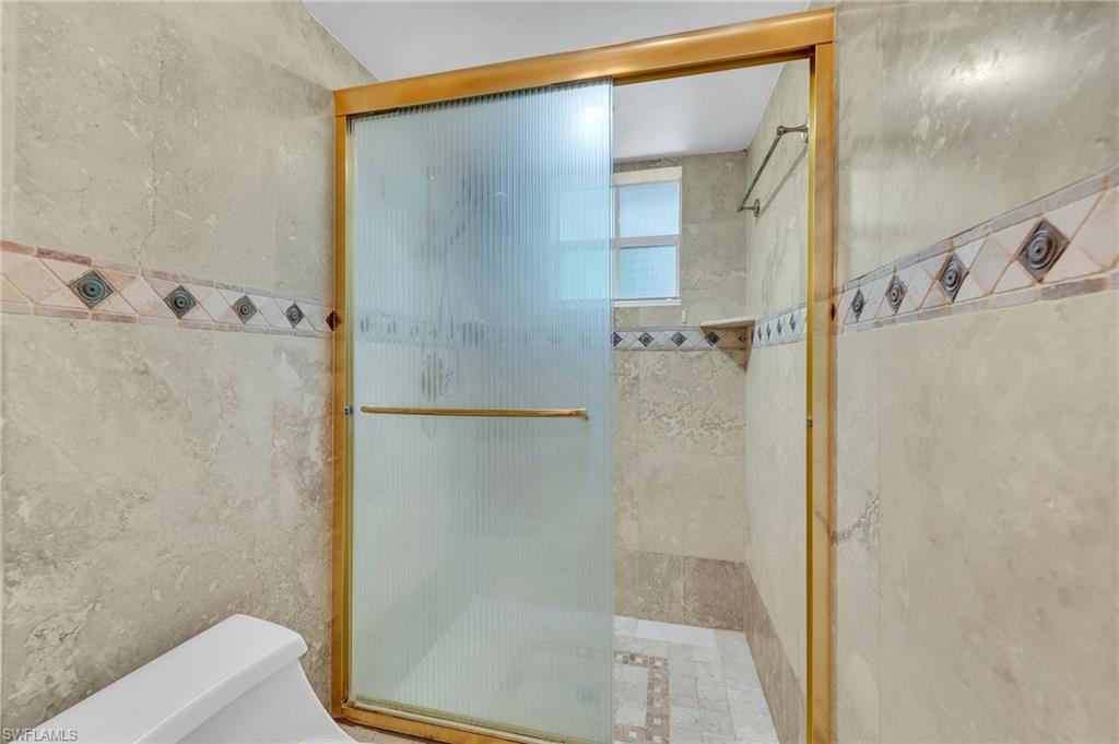 3065 50th Lane Southwest Naples, FL 34116 - Photo 16 of 31 a bathroom with a shower and a toilet