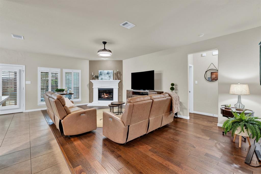 1701 Meadow Ranch Road McKinney, TX 75071 - Photo 9 of 40 a living room with furniture fireplace and flat screen tv