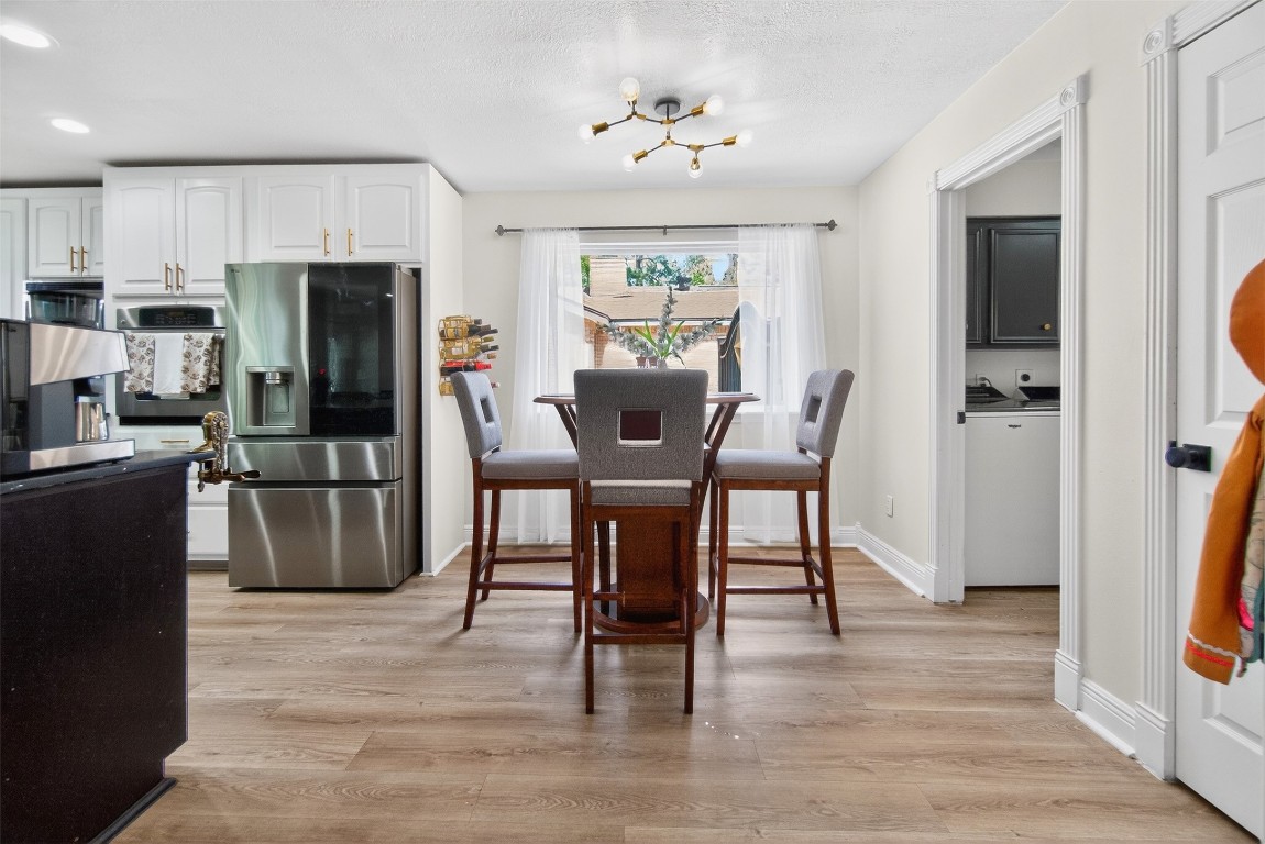 511 Enchanted Lane Spring, TX 77388 - Photo 11 of 38 a view of a dining room with furniture and wooden floor