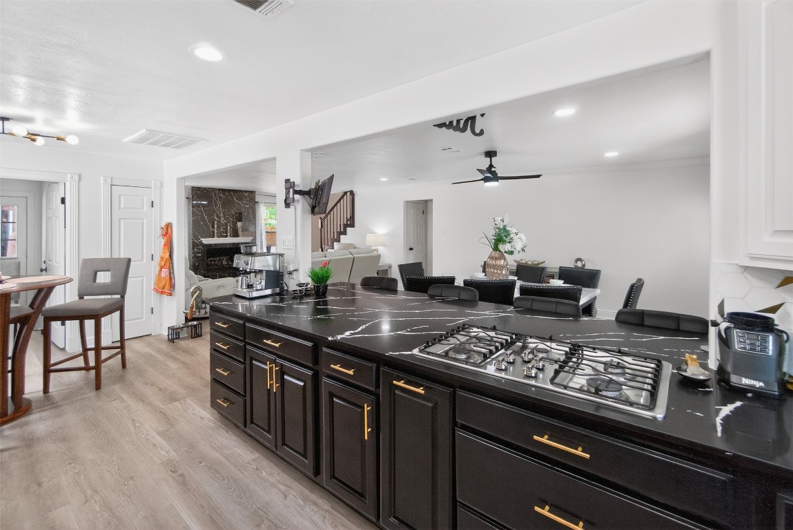 511 Enchanted Lane Spring, TX 77388 - Photo 13 of 38 a kitchen with stainless steel appliances granite countertop a stove top oven a sink dishwasher a dining table and chairs with wooden floor