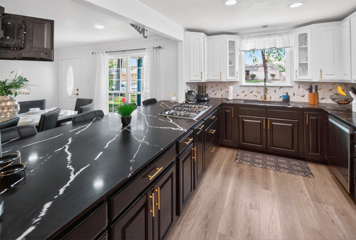 511 Enchanted Lane Spring, TX 77388 - Photo 15 of 38 a kitchen with stainless steel appliances granite countertop a sink counter space cabinets and a large window