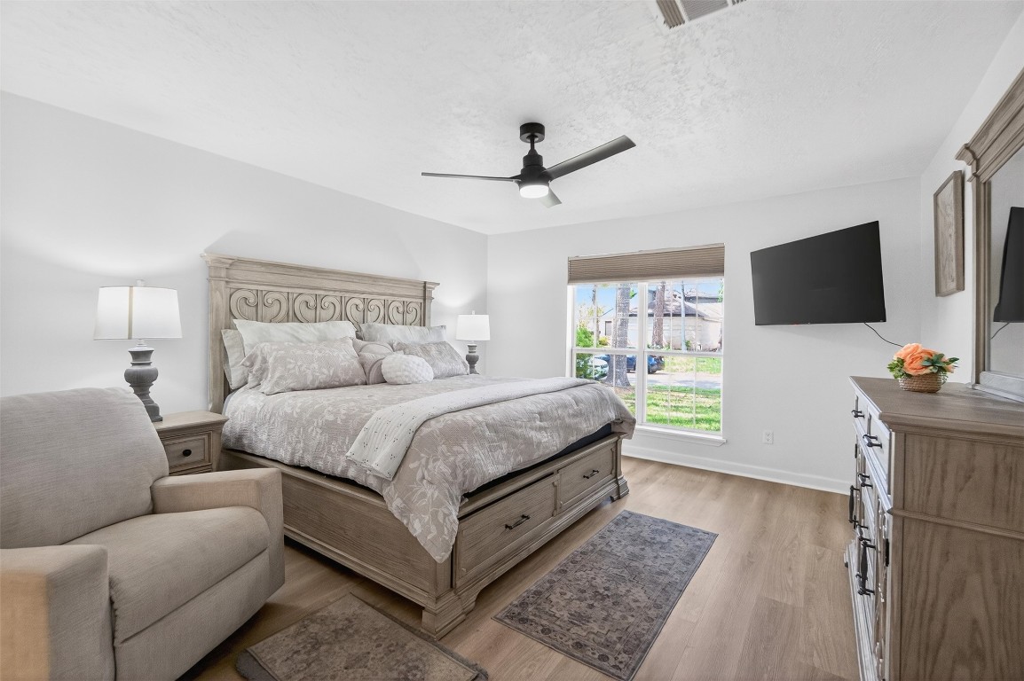 511 Enchanted Lane Spring, TX 77388 - Photo 20 of 38 a spacious bedroom with a bed and a flat screen television