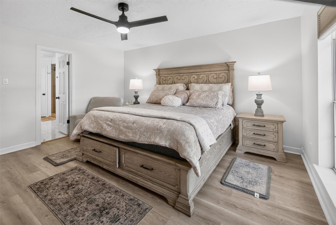 511 Enchanted Lane Spring, TX 77388 - Photo 21 of 38 a bedroom with a bed a rug and wooden floor