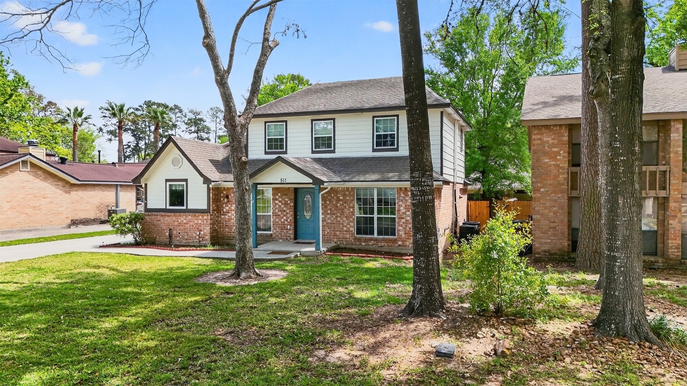 511 Enchanted Lane Spring, TX 77388 - Photo 3 of 38 a front view of a house with a yard and potted plants