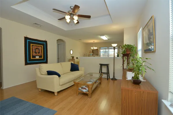 a living room with furniture and a chandelier